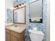 Clean bathroom with blue patterned walls and wood vanity at 1236 Fleetwood Nw Dr, Port Charlotte, FL 33948
