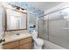 Bathroom with shower/tub combo, blue patterned walls, and wood vanity at 1236 Fleetwood Nw Dr, Port Charlotte, FL 33948