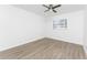 Simple bedroom with ceiling fan and wood-look floors at 1236 Fleetwood Nw Dr, Port Charlotte, FL 33948