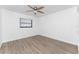 Spacious bedroom with hardwood floors and a ceiling fan at 1236 Fleetwood Nw Dr, Port Charlotte, FL 33948