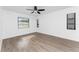 Spacious bedroom with ceiling fan and wood-look floors at 1236 Fleetwood Nw Dr, Port Charlotte, FL 33948