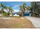 Single-story home with blue garage door and palm trees at 1236 Fleetwood Nw Dr, Port Charlotte, FL 33948