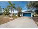 Single-story home with blue garage door and driveway at 1236 Fleetwood Nw Dr, Port Charlotte, FL 33948