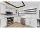 Modern kitchen with white cabinets and floating shelves at 1236 Fleetwood Nw Dr, Port Charlotte, FL 33948