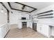 Modern kitchen with white cabinets, quartz counters, and wood beams at 1236 Fleetwood Nw Dr, Port Charlotte, FL 33948