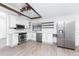 Modern white kitchen with stainless steel appliances and wood accents at 1236 Fleetwood Nw Dr, Port Charlotte, FL 33948