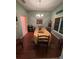 Elegant dining room with a large table, chandelier, and hardwood floors at 1281 Nebraska Ln, North Port, FL 34286