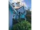House with teal accents, solar panels, and landscaping at 1281 Nebraska Ln, North Port, FL 34286