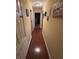 Long hallway with wood flooring leading to other rooms at 1281 Nebraska Ln, North Port, FL 34286