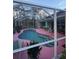 Pink-tiled pool with a screened enclosure at 1281 Nebraska Ln, North Port, FL 34286