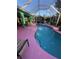 Inviting kidney-shaped pool with pink deck and screened enclosure at 1281 Nebraska Ln, North Port, FL 34286