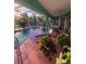 Beautiful kidney-shaped pool with pink deck and screened enclosure at 1281 Nebraska Ln, North Port, FL 34286
