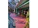 Refreshing kidney-shaped pool with pink deck and screened enclosure at 1281 Nebraska Ln, North Port, FL 34286