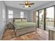 King sized bedroom with tile floors, ceiling fan, and balcony access at 1340 Rock Dove Ct # 135, Punta Gorda, FL 33950