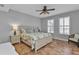 Bedroom with king bed, tile floors, and ceiling fan at 1340 Rock Dove Ct # 135, Punta Gorda, FL 33950
