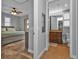 Spacious bedroom with ensuite bathroom, tile floors, and ceiling fan at 1340 Rock Dove Ct # 135, Punta Gorda, FL 33950