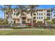 Building exterior with palm trees, fountain, and ample parking at 1340 Rock Dove Ct # 135, Punta Gorda, FL 33950
