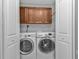 Convenient laundry room with washer, dryer, and cabinets at 1340 Rock Dove Ct # 135, Punta Gorda, FL 33950