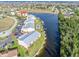 Aerial view showing waterfront property, community pool, and boat slips at 1348 Rock Dove Ct # C103, Punta Gorda, FL 33950