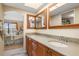 Double vanity bathroom with granite countertop and bedroom view at 1348 Rock Dove Ct # C103, Punta Gorda, FL 33950