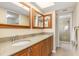 Double vanity bathroom with granite countertop and large mirror at 1348 Rock Dove Ct # C103, Punta Gorda, FL 33950