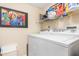 Laundry room with washer, dryer, and shelving at 1348 Rock Dove Ct # C103, Punta Gorda, FL 33950