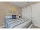 Bright bedroom with striped bedding and double door closet at 143 Uruguay Dr, Punta Gorda, FL 33983