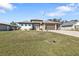 Single-story home with a two-car garage and landscaped lawn at 143 Uruguay Dr, Punta Gorda, FL 33983