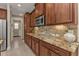 Kitchen with granite countertops and wooden cabinets at 143 Uruguay Dr, Punta Gorda, FL 33983
