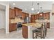 Open kitchen with granite island, stainless steel appliances, and wood cabinets at 143 Uruguay Dr, Punta Gorda, FL 33983