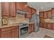 Modern kitchen with stainless steel appliances and granite countertops at 143 Uruguay Dr, Punta Gorda, FL 33983