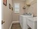 Bright laundry room with washer, dryer, and built-in shelving at 143 Uruguay Dr, Punta Gorda, FL 33983