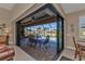 Bright living room with sliding glass doors opening to a pool and patio area at 143 Uruguay Dr, Punta Gorda, FL 33983