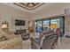 Comfortable living room featuring a pool view and coffered ceiling at 143 Uruguay Dr, Punta Gorda, FL 33983
