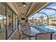 Covered patio overlooking refreshing pool at 143 Uruguay Dr, Punta Gorda, FL 33983