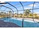 Inviting freeform swimming pool with screened enclosure at 143 Uruguay Dr, Punta Gorda, FL 33983