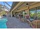 Relaxing poolside patio with seating area and screened enclosure at 143 Uruguay Dr, Punta Gorda, FL 33983