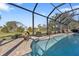 Refreshing screened pool with waterfall feature and lush landscaping at 143 Uruguay Dr, Punta Gorda, FL 33983