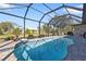 Inviting screened pool with waterfall feature and ample space at 143 Uruguay Dr, Punta Gorda, FL 33983