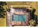 Aerial view of a screened-in pool with surrounding landscaping at 1434 Hedgewood Cir, North Port, FL 34288