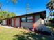 Well-maintained single-story home with a red door and landscaped yard at 1434 Viscaya Dr, Port Charlotte, FL 33952
