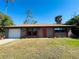 Ranch-style home with attached garage and landscaped yard at 1434 Viscaya Dr, Port Charlotte, FL 33952