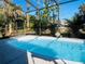 Inviting screened-in pool with tropical landscaping at 1434 Viscaya Dr, Port Charlotte, FL 33952