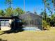 Screened pool area with patio furniture and lush landscaping at 1434 Viscaya Dr, Port Charlotte, FL 33952