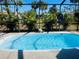 Inviting screened-in pool with tropical landscaping at 1434 Viscaya Dr, Port Charlotte, FL 33952