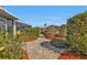 Landscaped backyard with a brick pathway at 162 Croop Se Ln, Port Charlotte, FL 33952