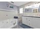 Bathroom with double vanity, soaking tub, and tiled shower at 162 Croop Se Ln, Port Charlotte, FL 33952