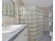 Bathroom featuring a glass block shower enclosure and single vanity at 162 Croop Se Ln, Port Charlotte, FL 33952