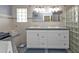 Bathroom with double vanity, glass block shower, and tiled floors at 162 Croop Se Ln, Port Charlotte, FL 33952