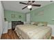 Bedroom with king-size bed, ceiling fan, and wood flooring at 162 Croop Se Ln, Port Charlotte, FL 33952